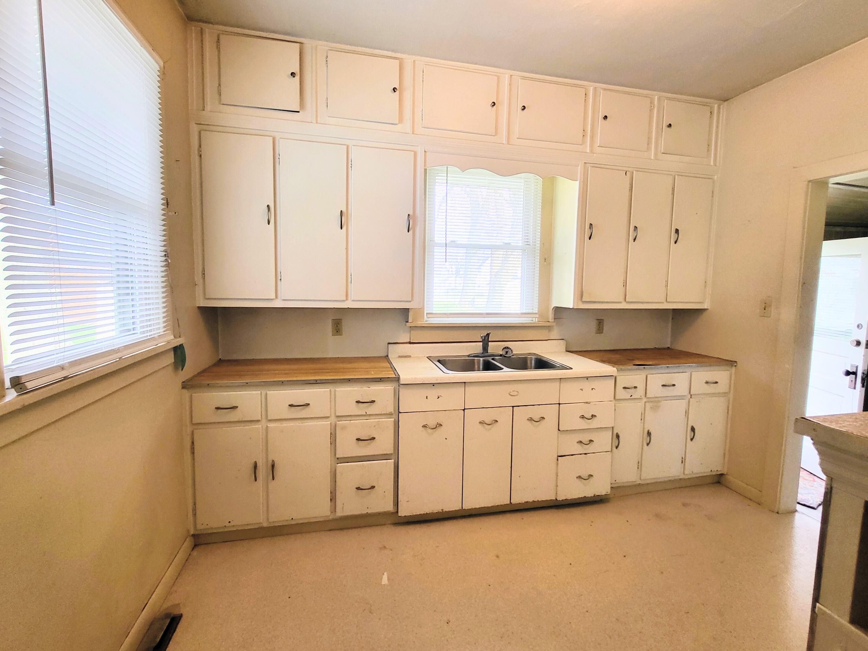 509 North Cullen Street Rensselaer, IN 47978 - Photo 4 of 16 a large white kitchen with granite countertop white cabinets