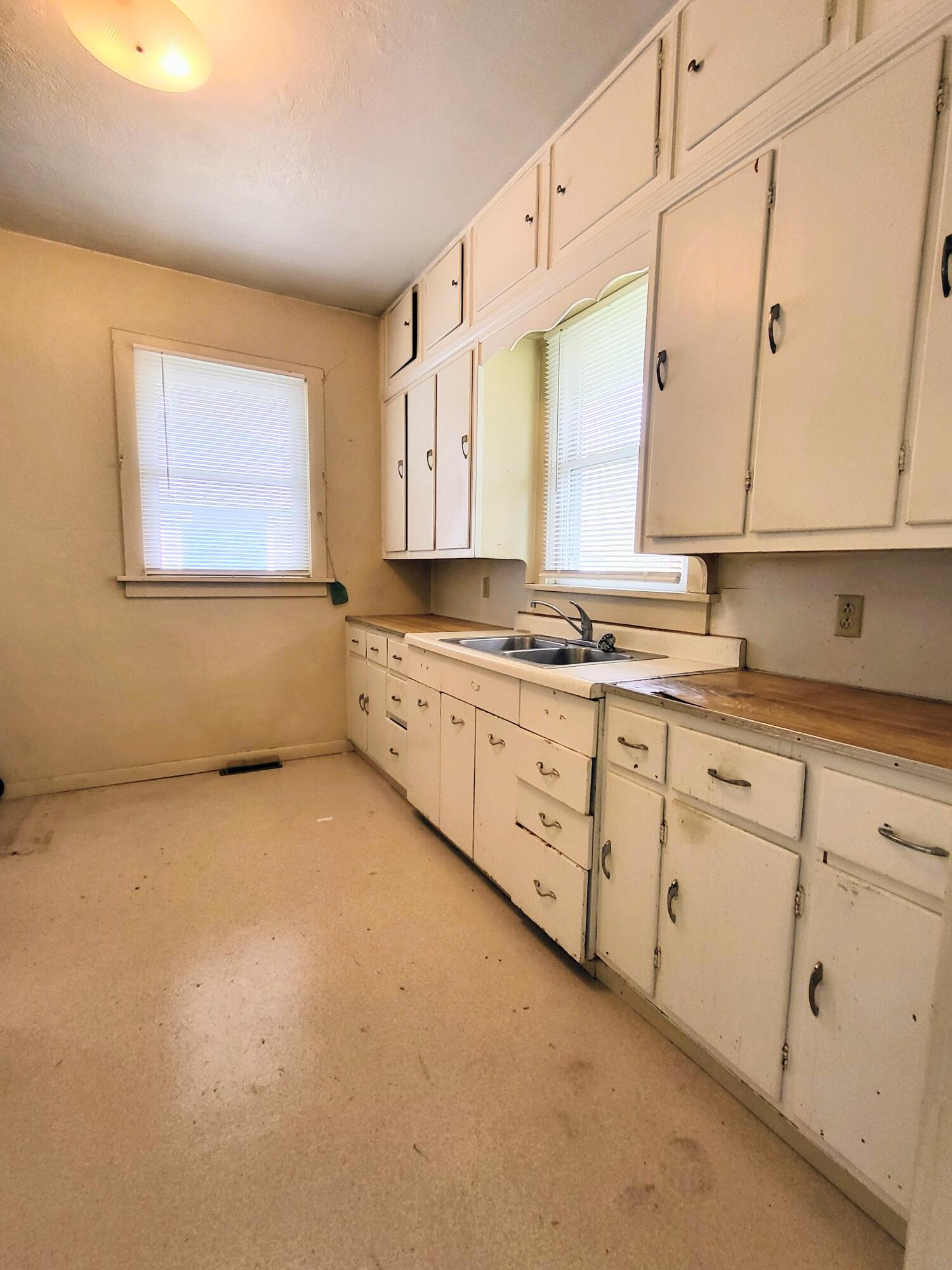 509 North Cullen Street Rensselaer, IN 47978 - Photo 5 of 16 a kitchen with stainless steel appliances granite countertop a sink a stove and white cabinets