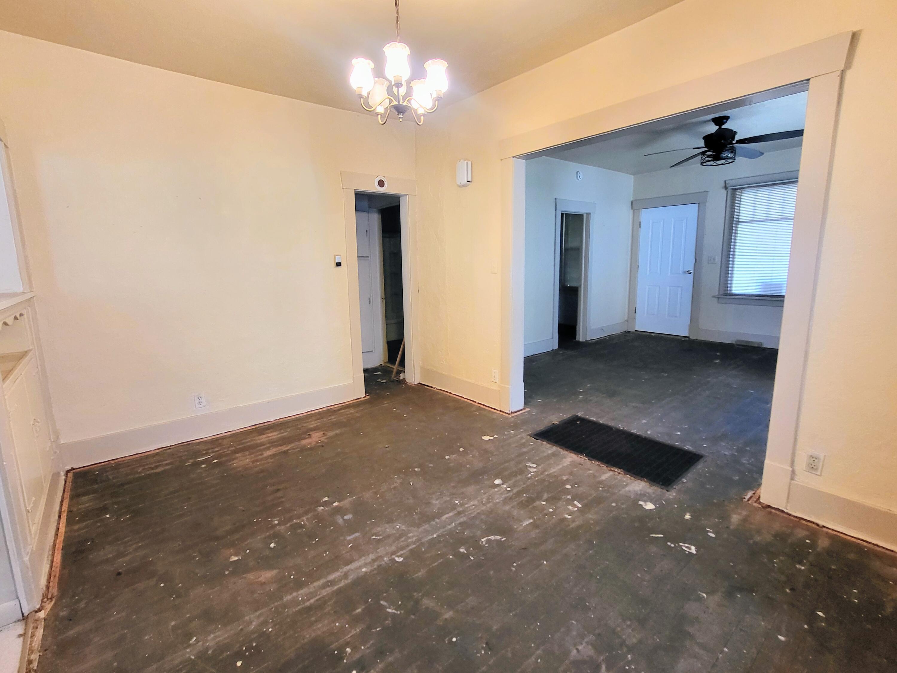 509 North Cullen Street Rensselaer, IN 47978 - Photo 8 of 16 an empty room with a chandelier fan and windows