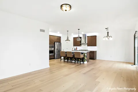 a view of kitchen with refrigerator and dining table