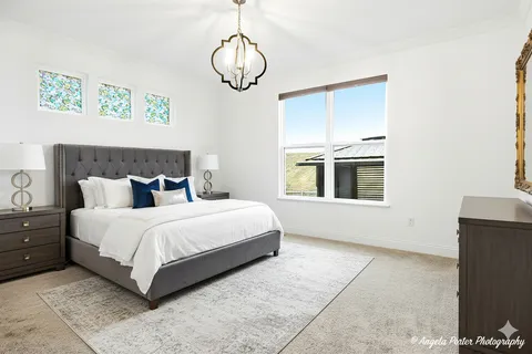 a spacious bedroom with a bed and window