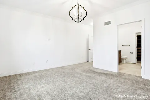 a view of a room with wooden floor and white walls