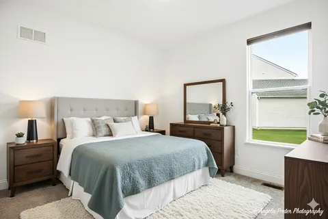 a bedroom with a bed and a window