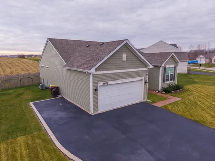 a view of a house with a yard and garage