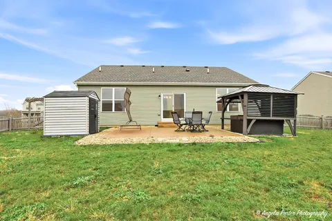 a view of a house with pool and chairs