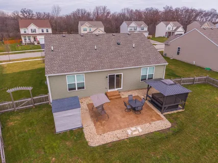 an aerial view of a house with swimming pool
