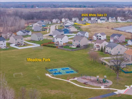 a view of swimming pool with a table and chairs in patio