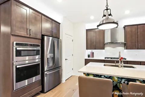 a kitchen with stainless steel appliances a refrigerator and a sink