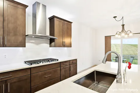 a kitchen with a sink cabinets and window