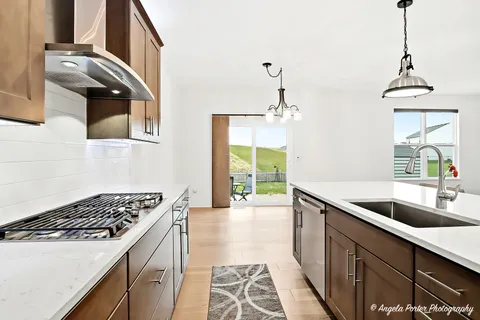 a kitchen with stainless steel appliances granite countertop a sink stove and cabinets