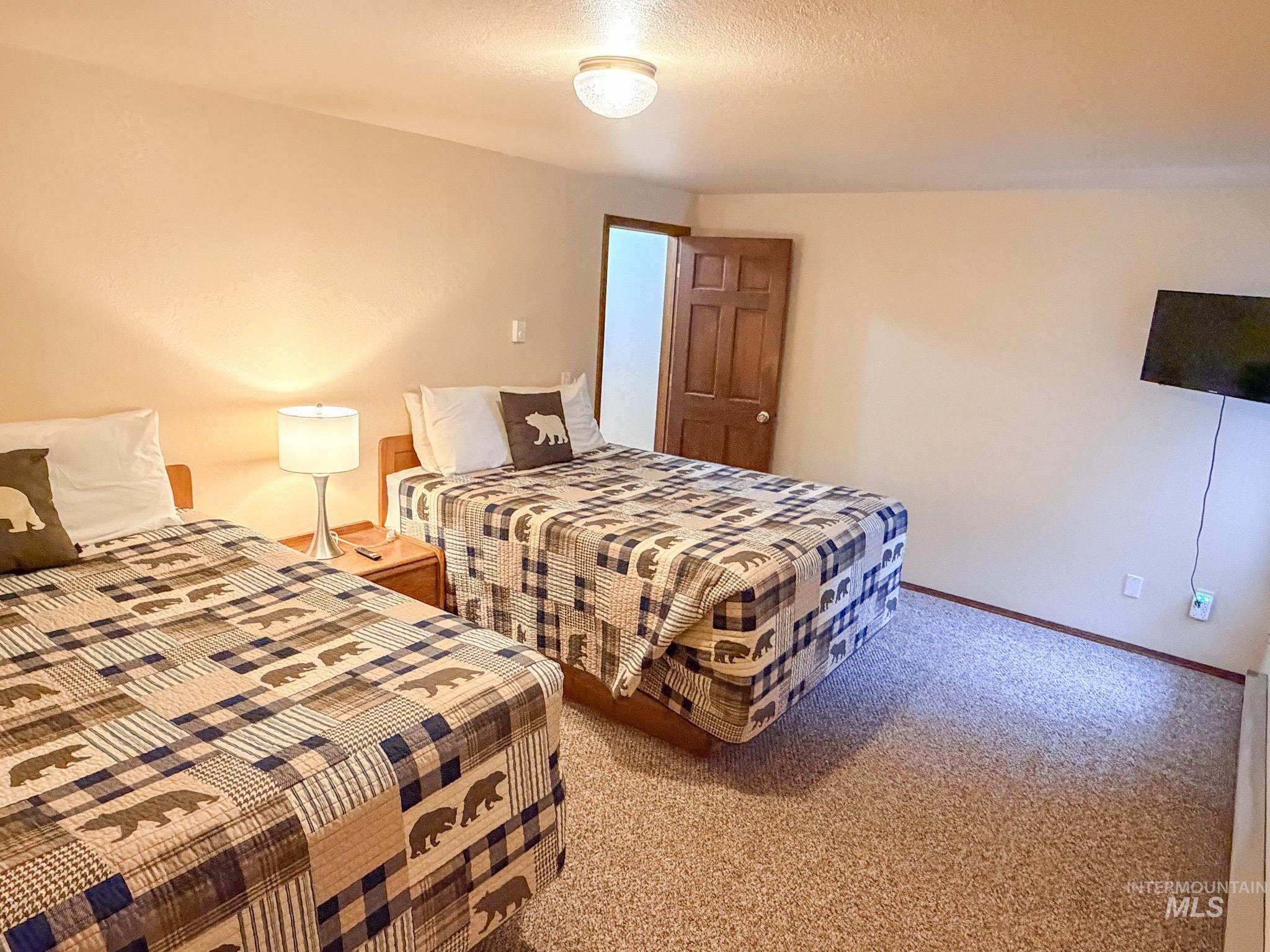1630 Davis Avenue, Unit F46 McCall, ID 83638 - Photo 18 of 23 Carpeted bedroom featuring a textured ceiling and baseboards