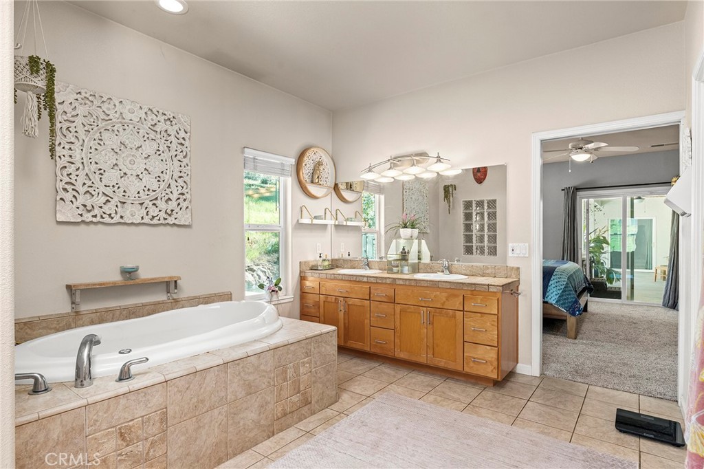 2262 Honey Run Road Chico, CA 95928 - Photo 17 of 74 a spacious bathroom with a granite countertop sink and a large mirror