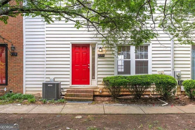 a front view of a house with a yard and sitting area