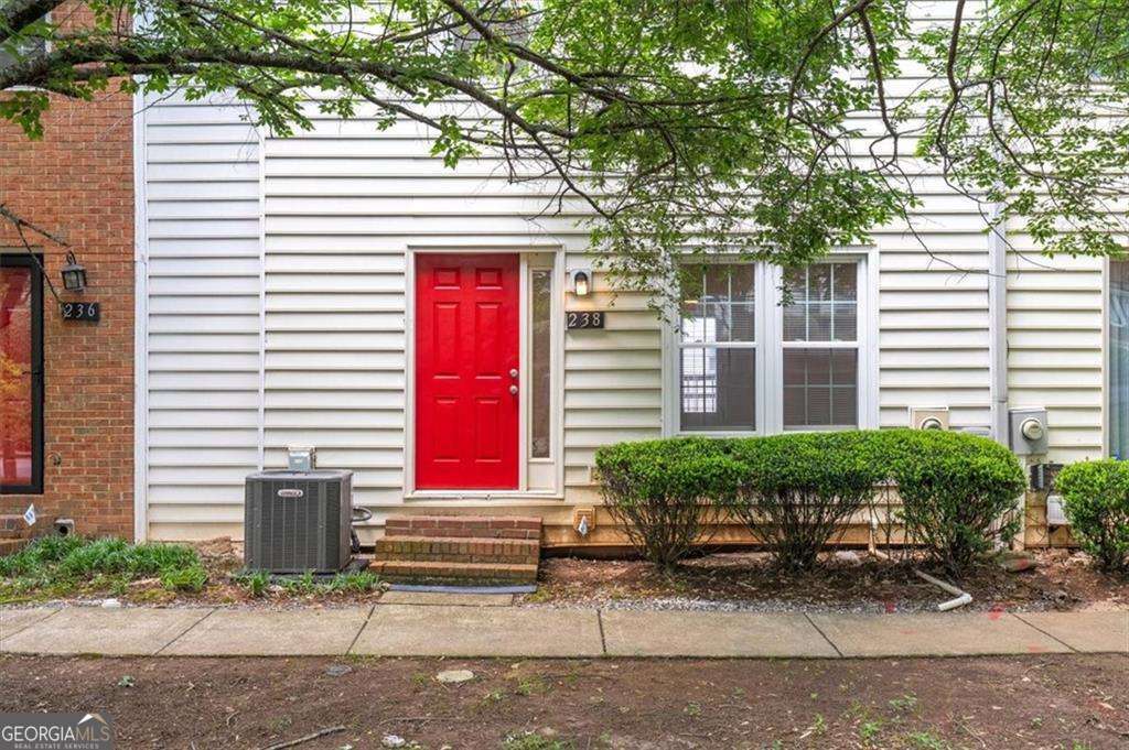 238 Chads Ford Way Roswell, GA 30076 - Photo 1 of 1 a front view of a house with a yard and sitting area