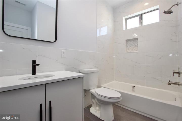 1608 North 3rd Street Philadelphia, PA 19122 - Photo 6 of 28 a bathroom with a sink a toilet and bathtub
