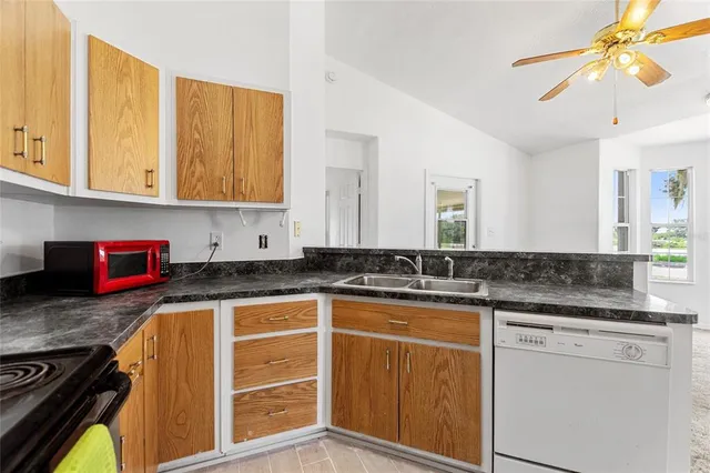 a kitchen with stainless steel appliances granite countertop a stove a sink and a granite counter tops