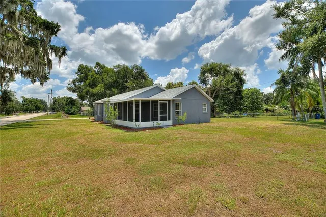 a view of a backyard with sitting area