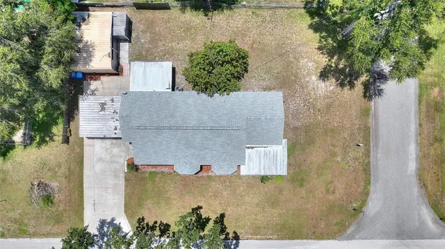 an aerial view of lake and residential houses with outdoor space and swimming pool
