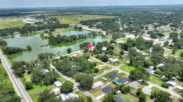 an aerial view of residential houses with outdoor space and lake view