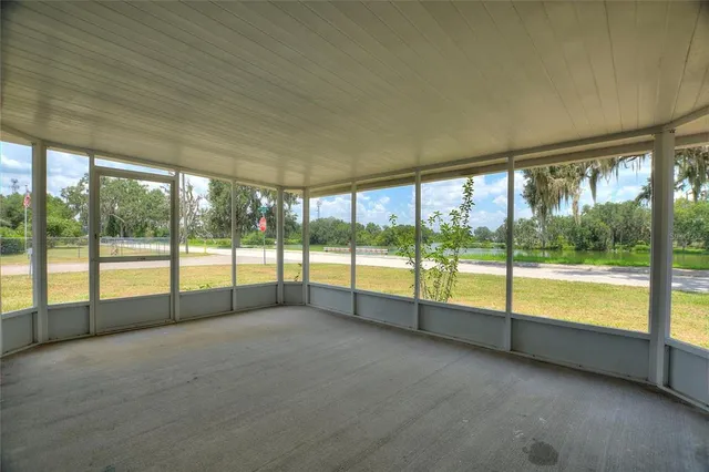 a view of an empty room with large windows