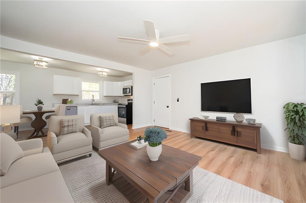 3015 South Van Wert Road Villa Rica, GA 30180 - Photo 1 of 1 a living room with furniture and a flat screen tv