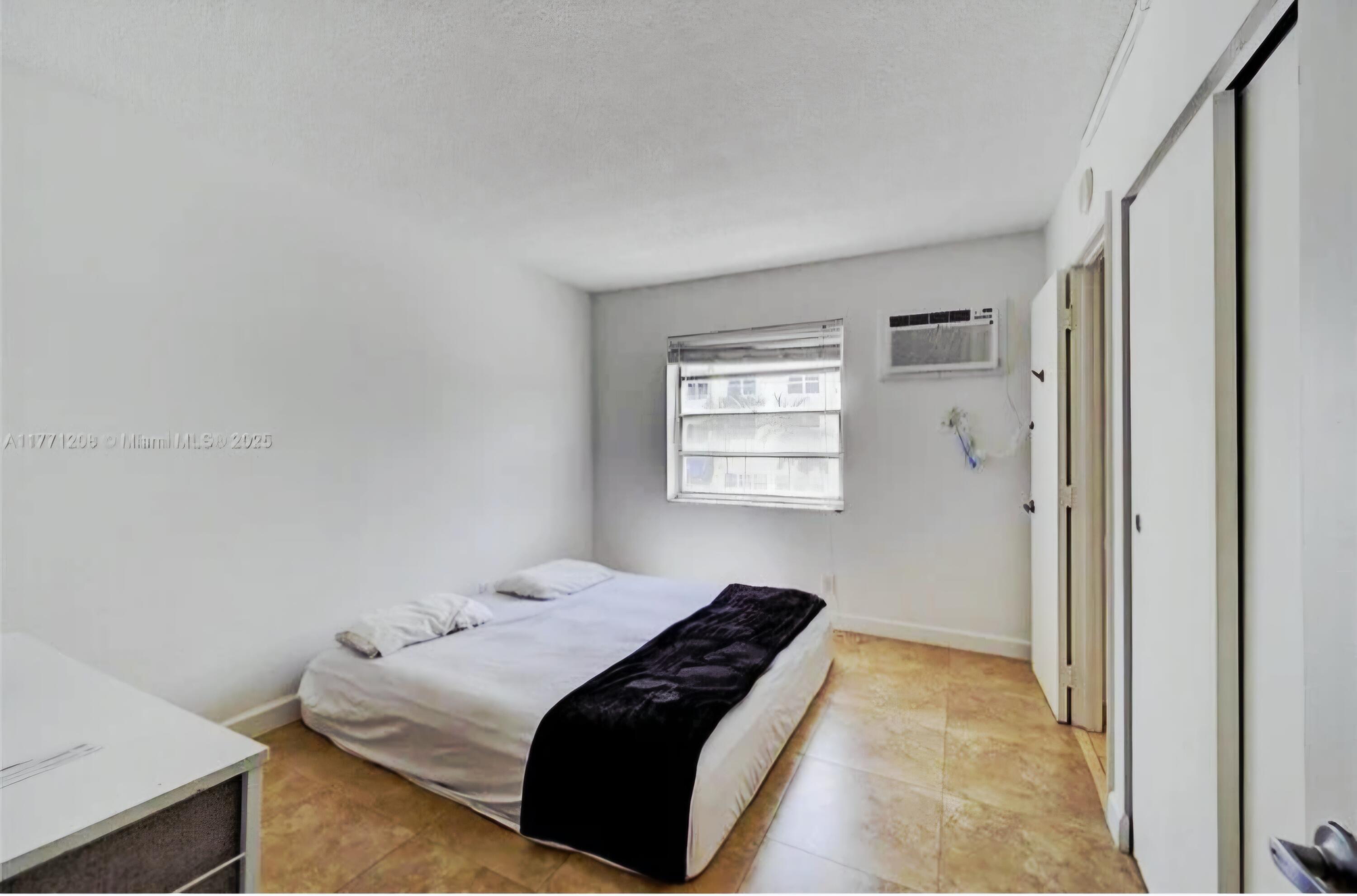 200 South Birch Road, Unit 208 Fort Lauderdale, FL 33316 - Photo 13 of 22 a bedroom with a bed and a window