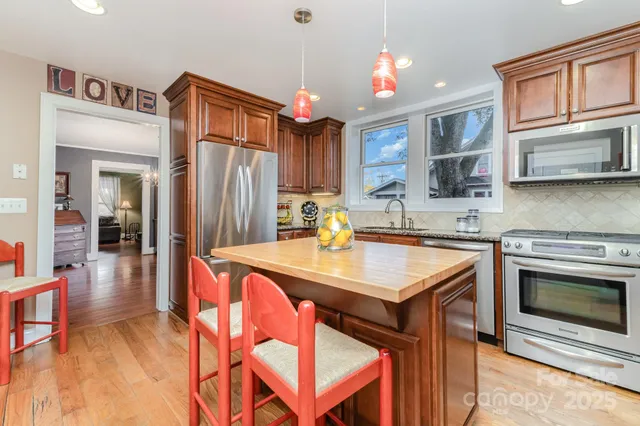 a large kitchen with a table and chairs in it