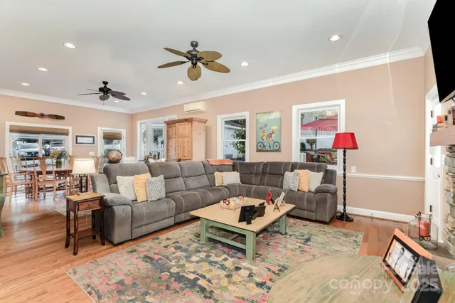 a living room with furniture and view of kitchen