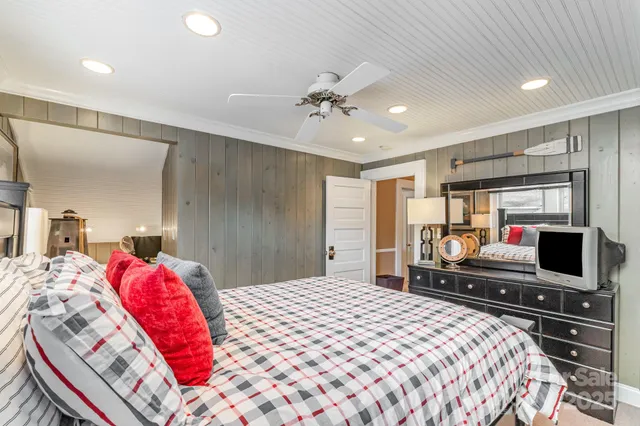 a bedroom with a bed and a chandelier