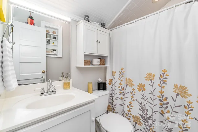 a bed room with a bed mirror and a window