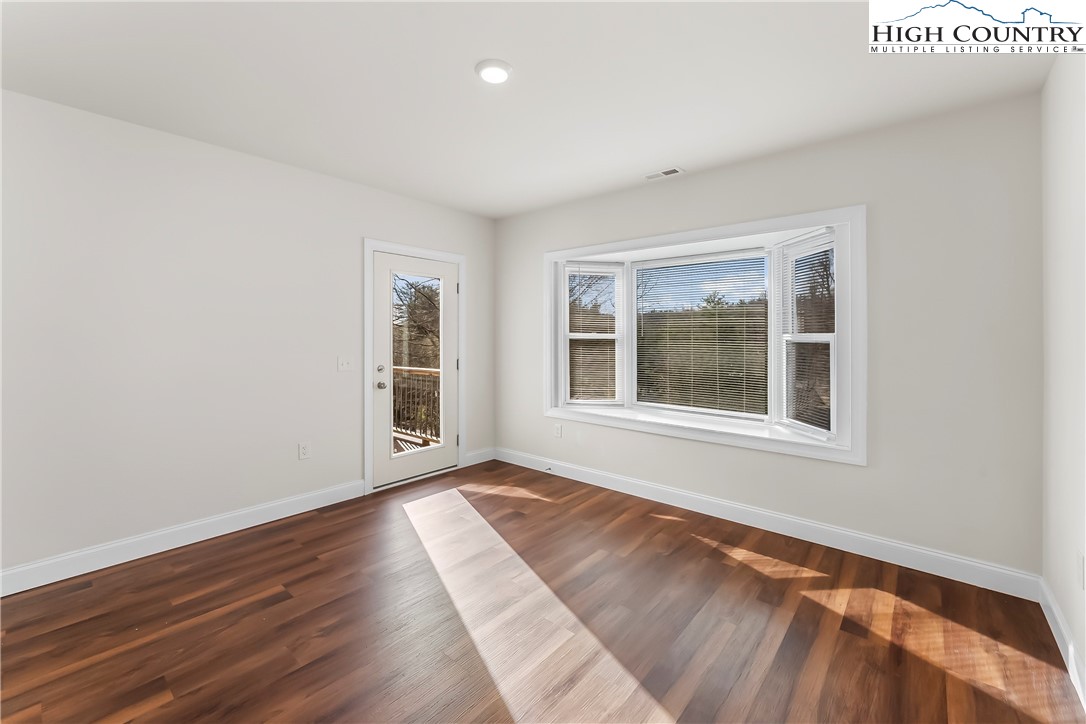 262 Old Bristol Road Boone, NC 28607 - Photo 19 of 38 a view of an empty room with wooden floor and a window