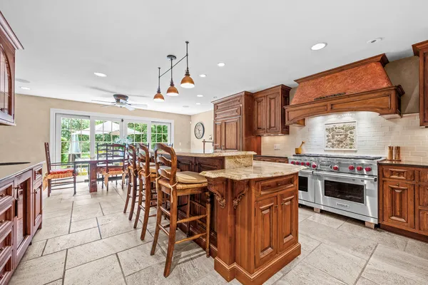 a kitchen with a stove top oven a sink a counter top space and cabinets