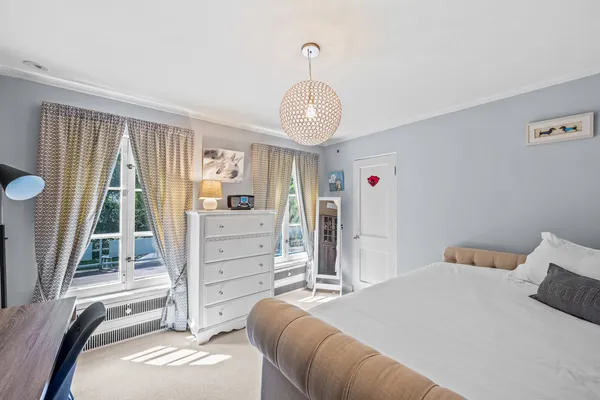 a bathroom with a double vanity sink toilet mirror and window
