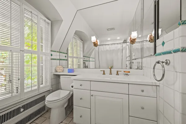 a bed sitting in a bedroom next to a lamp