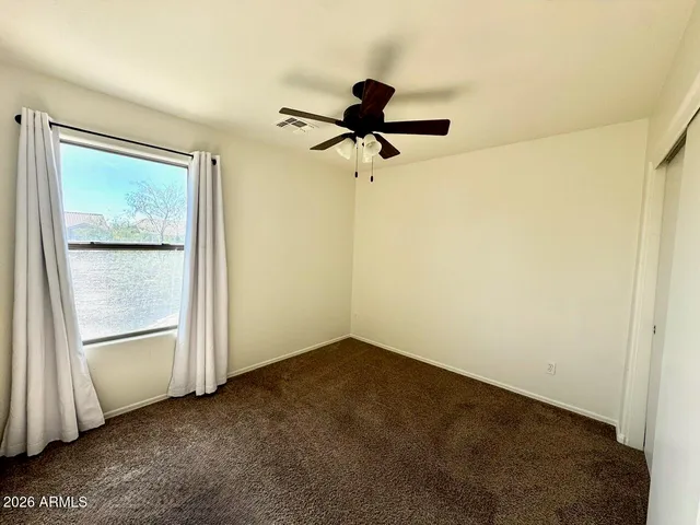 a view of room with a ceiling fan