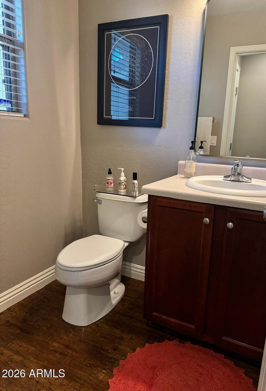 3555 East Michelle Way Gilbert, AZ 85234 - Photo 17 of 18 a bathroom with a toilet a sink and mirror
