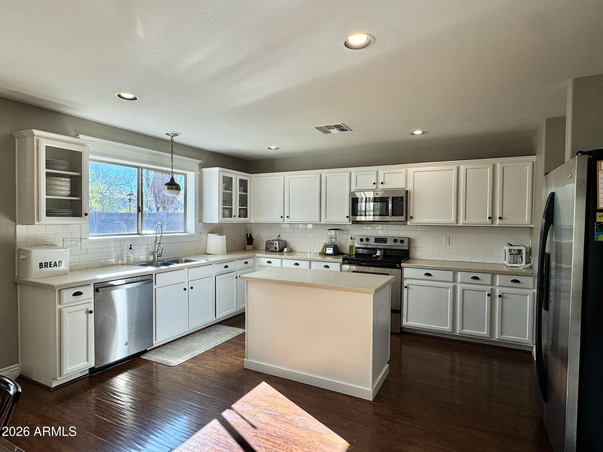 3555 East Michelle Way Gilbert, AZ 85234 - Photo 2 of 18 a kitchen with stainless steel appliances granite countertop a sink stove and refrigerator
