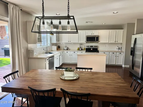 a view of kitchen with sink dining table and chairs