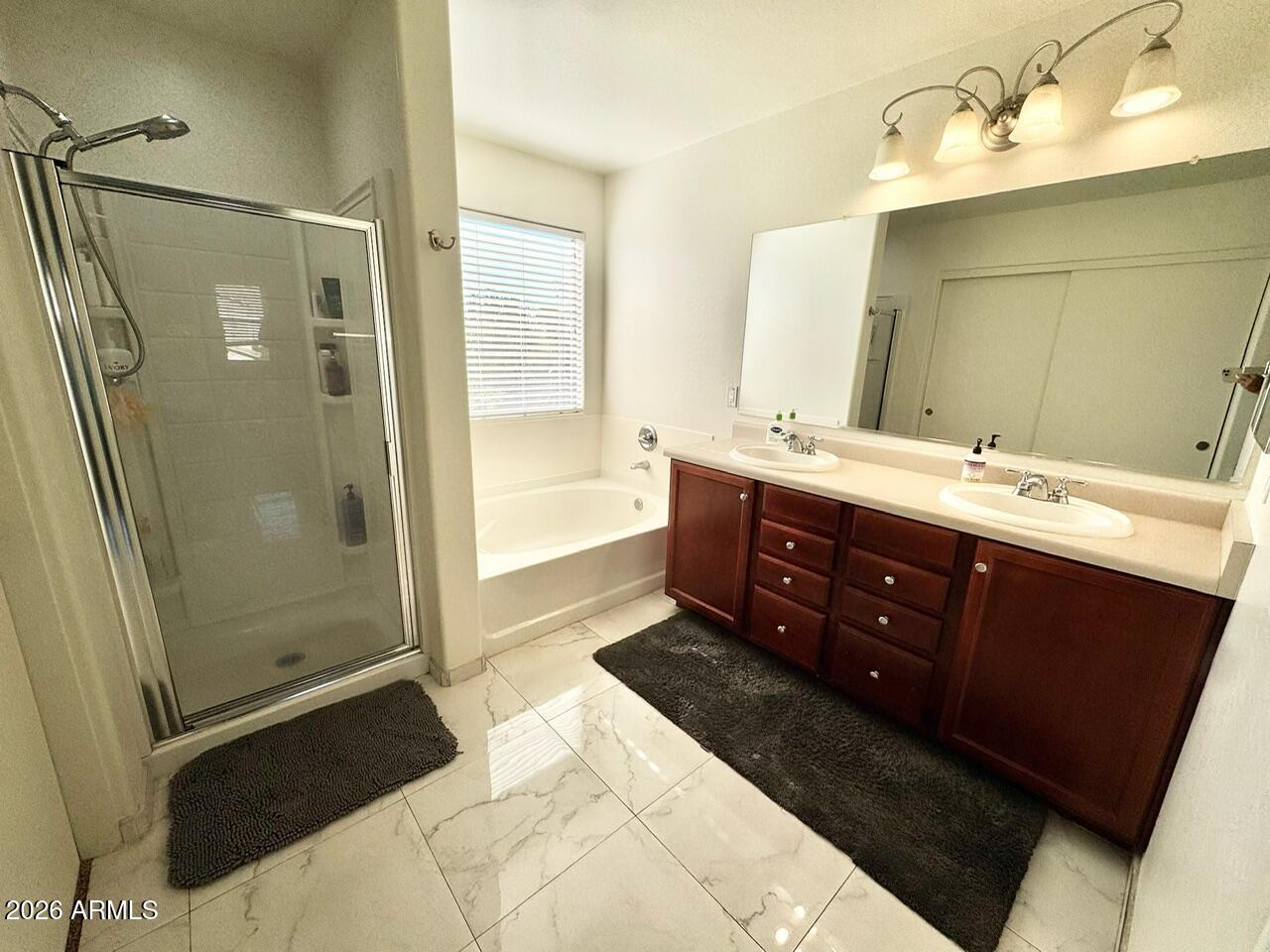 3555 East Michelle Way Gilbert, AZ 85234 - Photo 10 of 18 a spacious bathroom with a double vanity sink toilet mirror and shower
