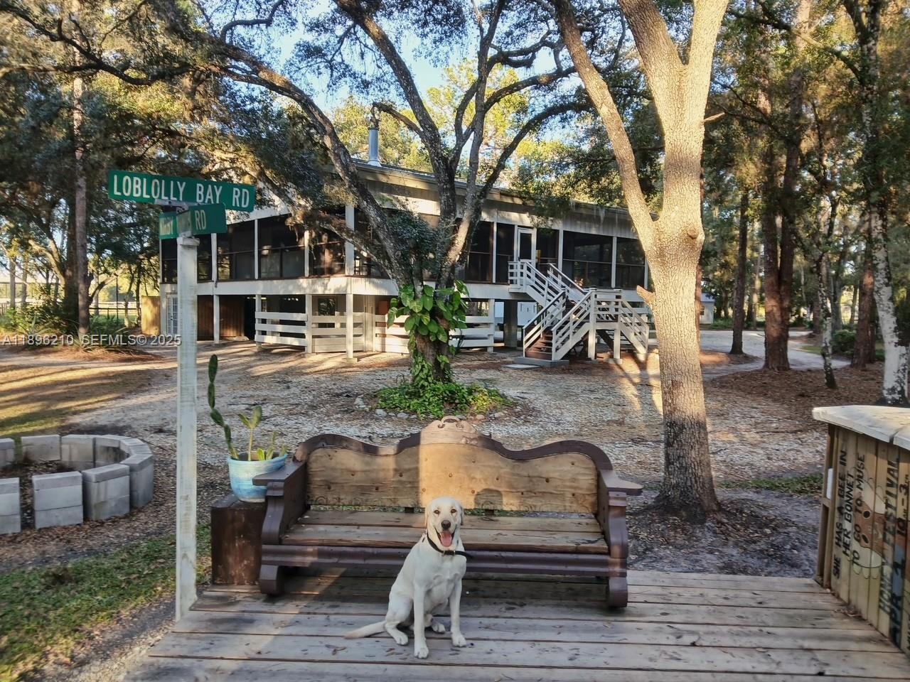 1270 Tom Coker Road LaBelle, FL 33935 - Photo 1 of 46 a front view of a house with garden