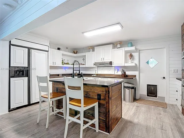 a kitchen with stainless steel appliances a stove a refrigerator sink and cabinets