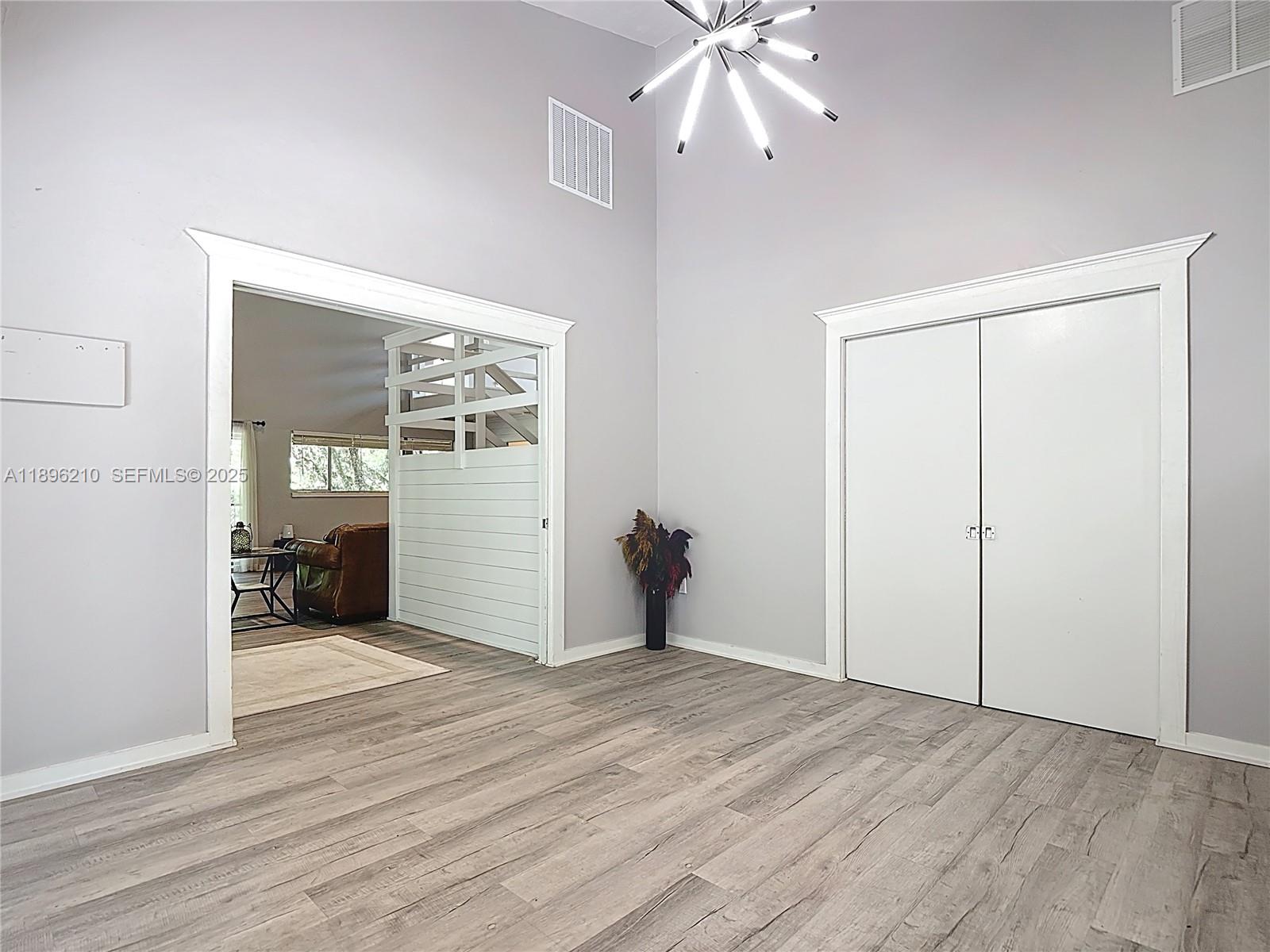 1270 Tom Coker Road LaBelle, FL 33935 - Photo 15 of 46 an empty room with wooden floor and windows