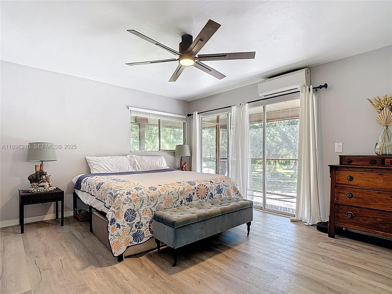 1270 Tom Coker Road LaBelle, FL 33935 - Photo 21 of 46 a bedroom with a bed and a dresser next to a window