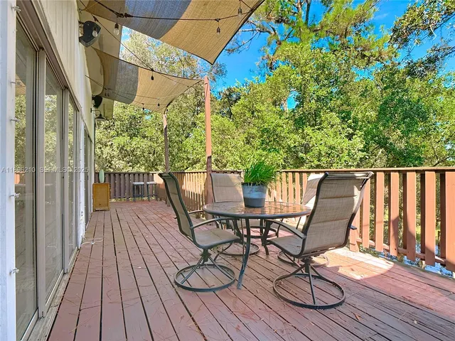 a view of balcony with wooden floor and outdoor seating
