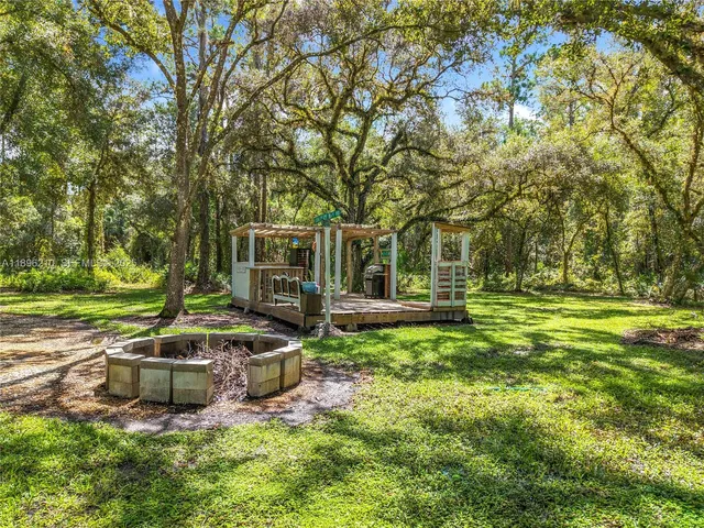 a view of a wooden deck with a yard