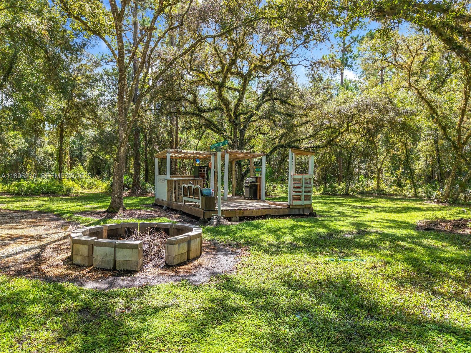 1270 Tom Coker Road LaBelle, FL 33935 - Photo 32 of 46 a view of a house with a yard porch and sitting area