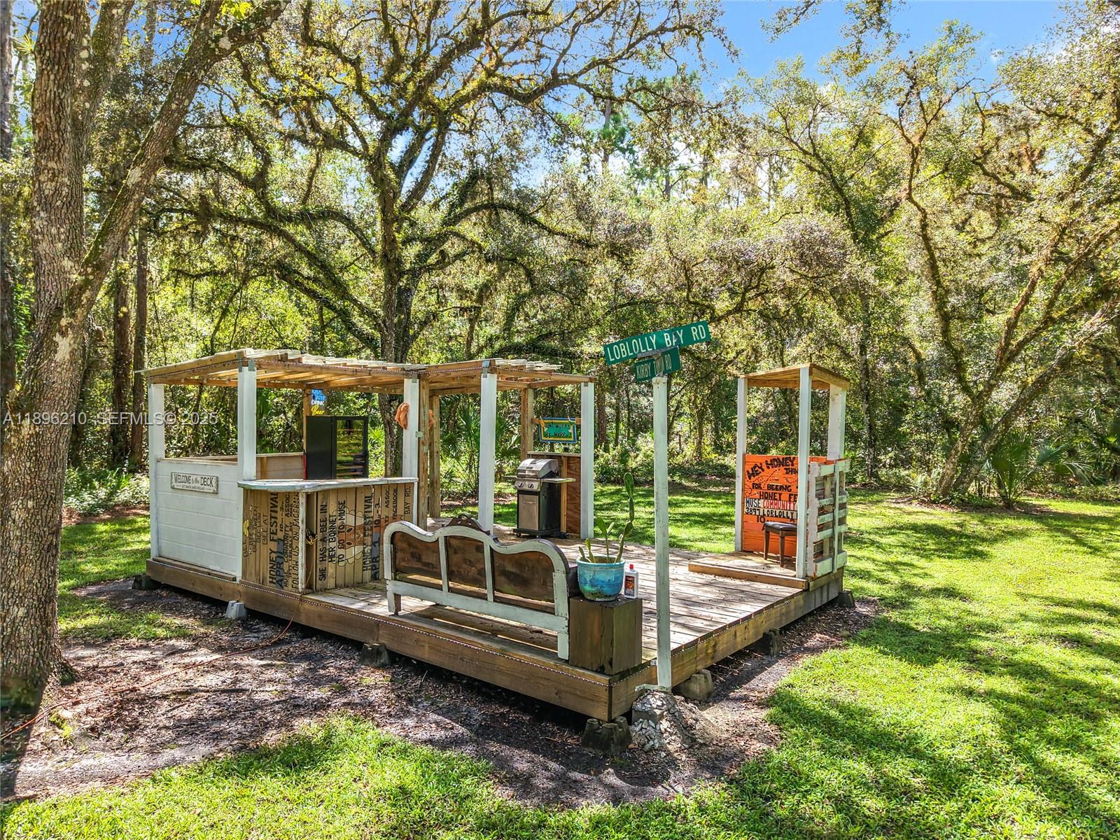 1270 Tom Coker Road LaBelle, FL 33935 - Photo 33 of 46 a view of a wooden deck with a yard