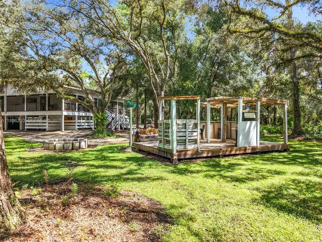 a view of a house with a large window and brick wall