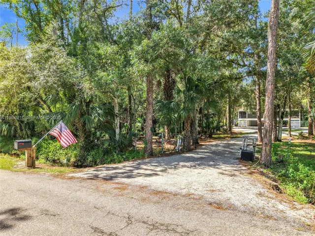an aerial view of a house with a yard and garden