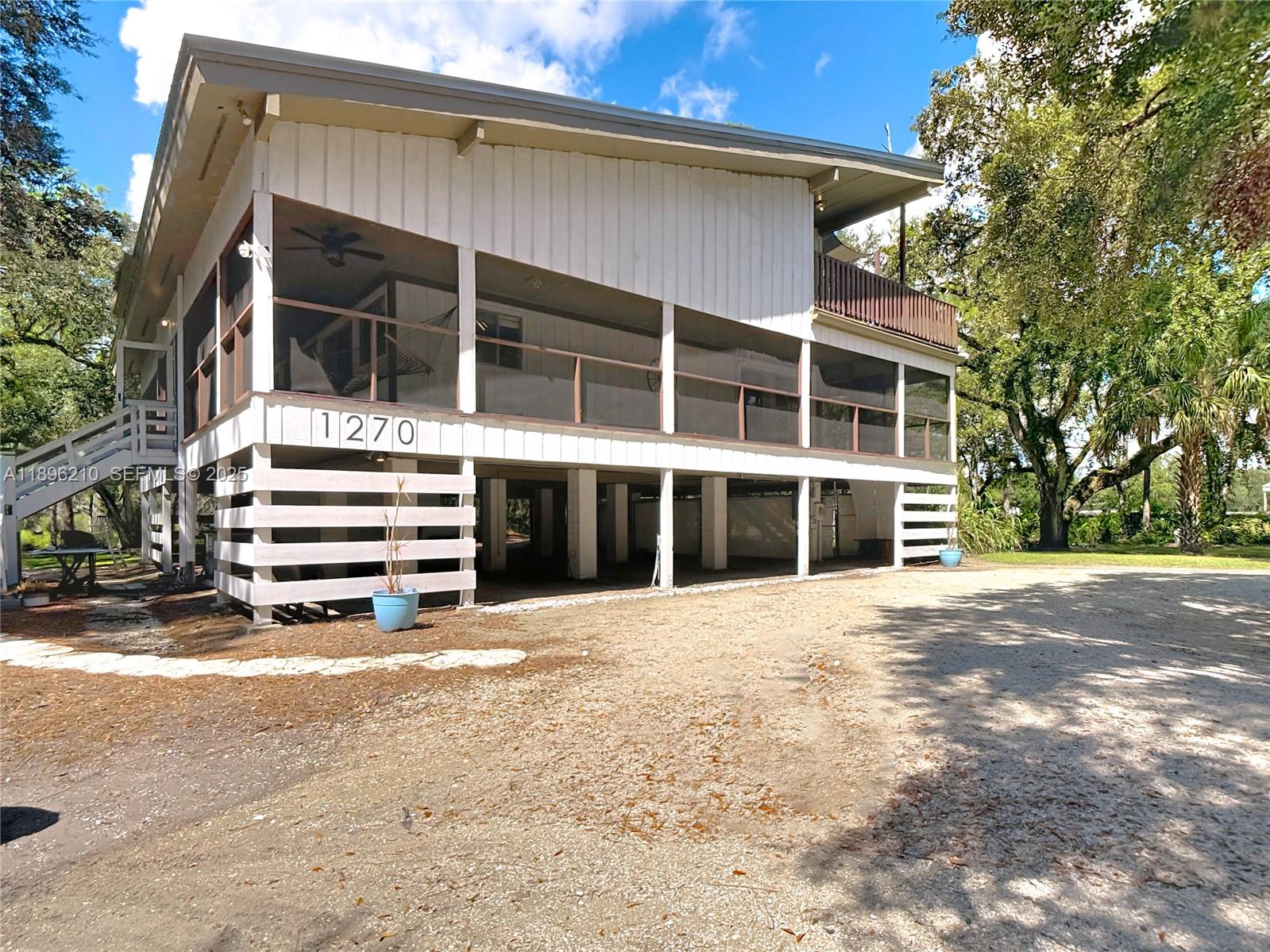 1270 Tom Coker Road LaBelle, FL 33935 - Photo 5 of 46 a view of a house with a large window and yard